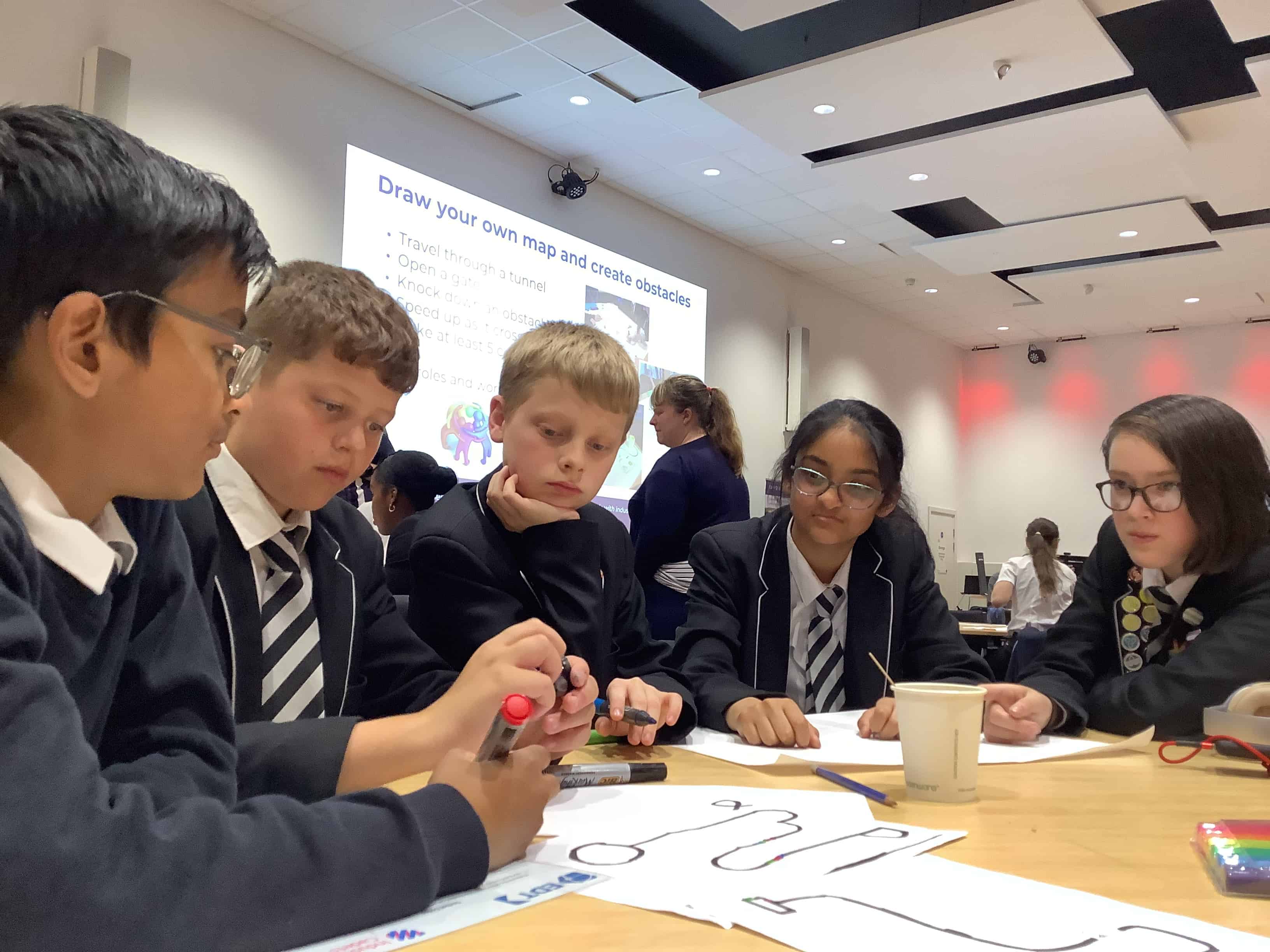 A team of Laurus Ryecroft students working together to programme their nanobot at the Industrial Cadet Awards at Sheffield Hallam University.