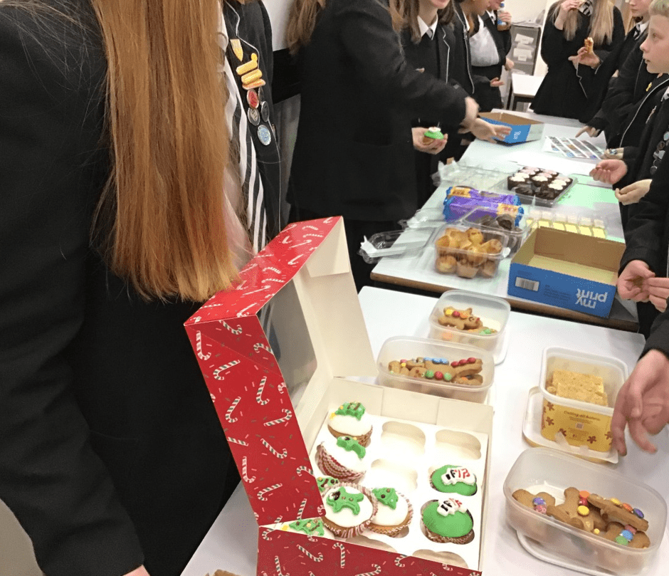 student sells cupcakes at bake sale