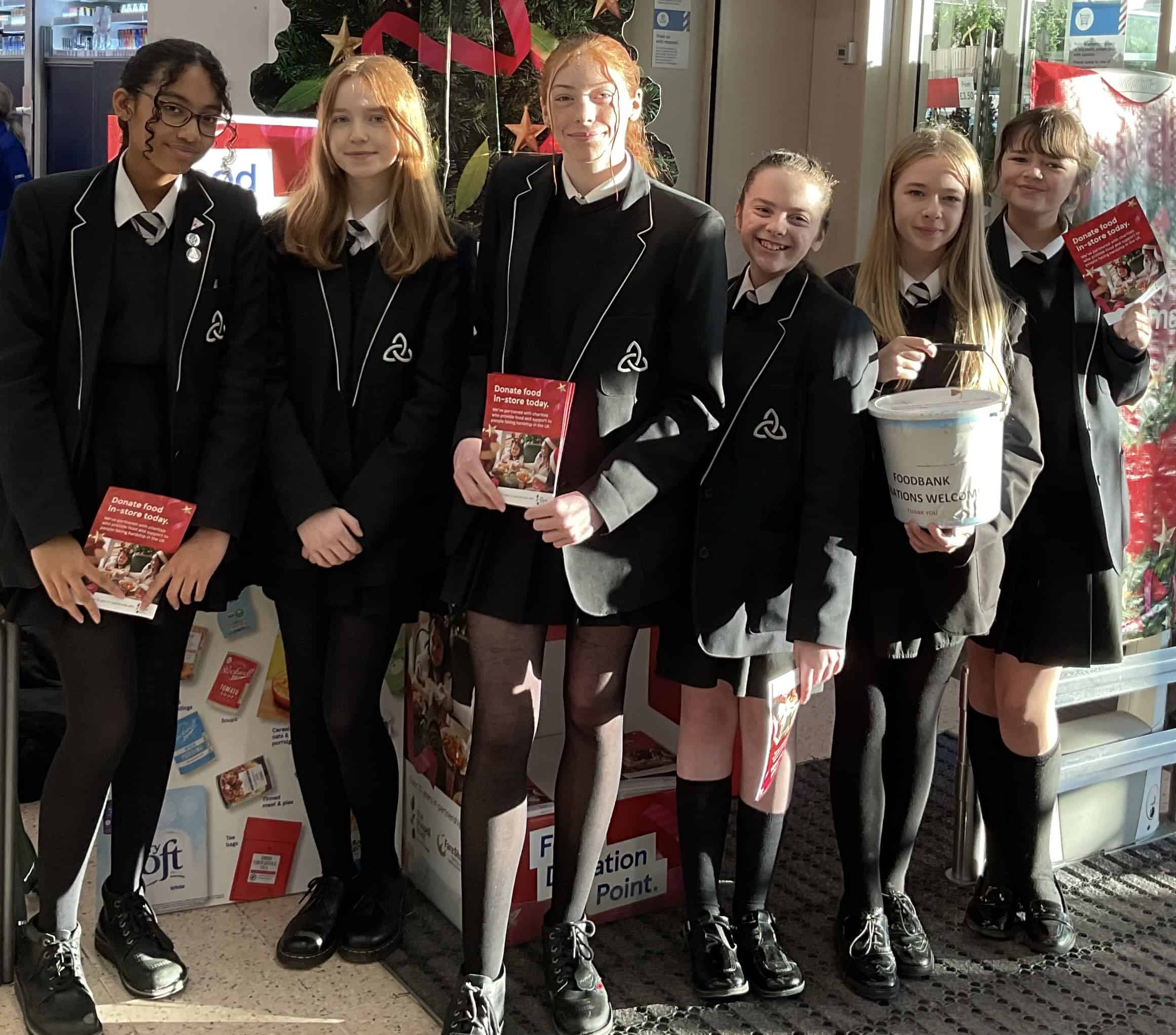 Laurus Ryecroft students stand in Tesco during their fundraising.