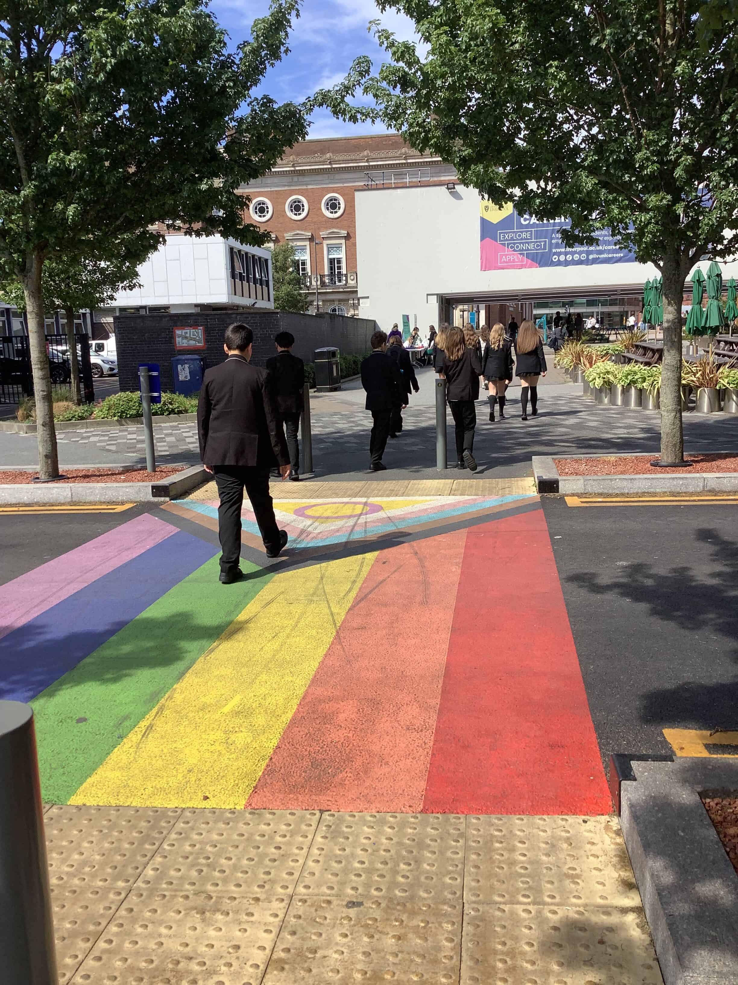 Students from Laurus Ryecroft visit the University of Liverpool and have a guided tour. They walk between buildings over a colourful decorated crossing.