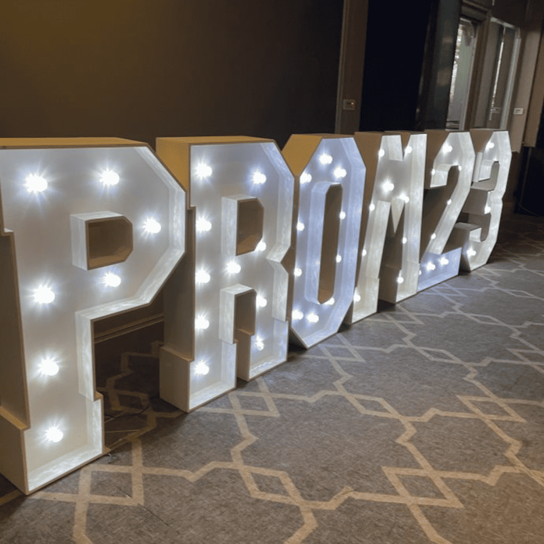 A light up letter sign at Laurus Ryecroft prom reads: PROM 2023