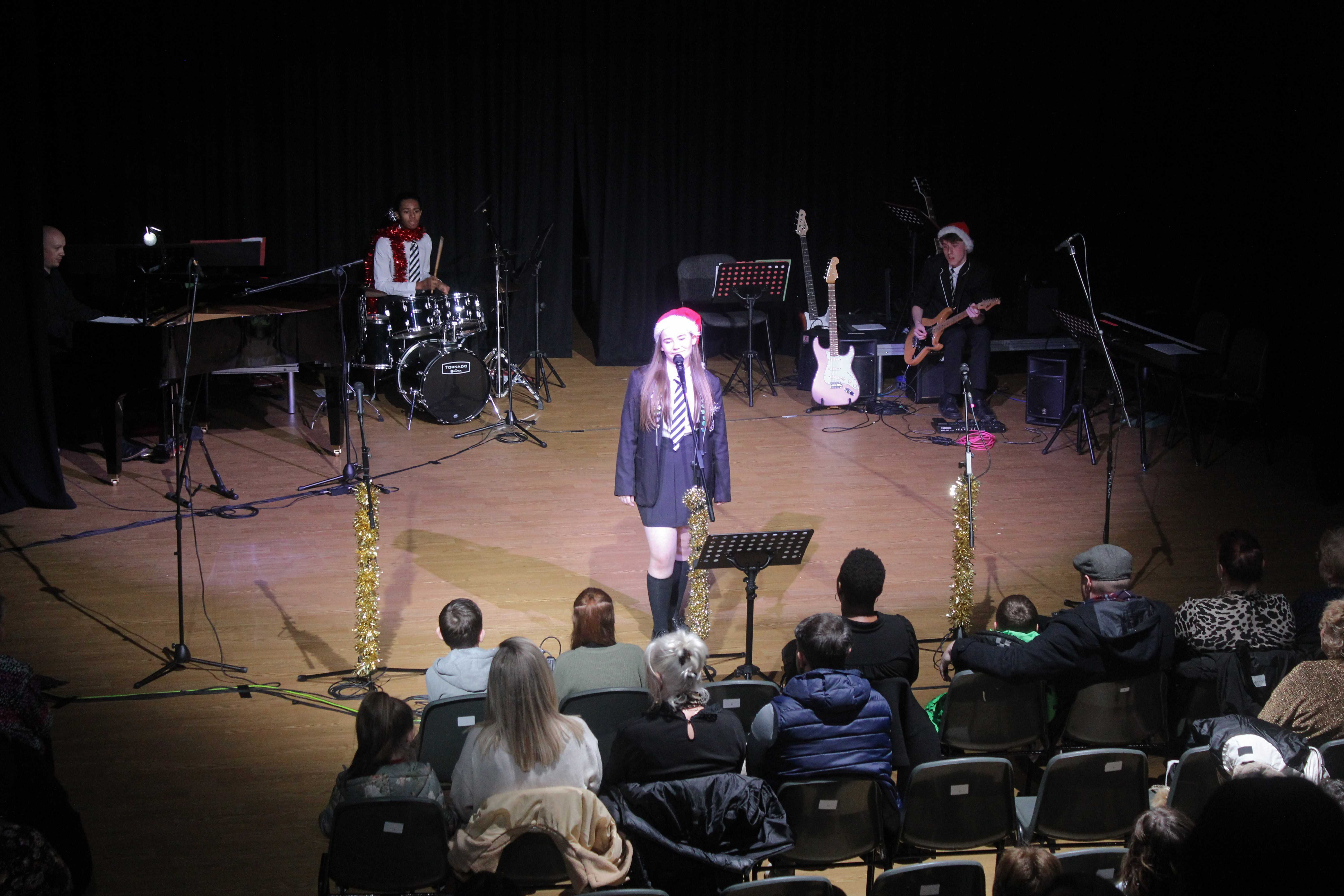 Students perform in a band wearing Christmas hats at Laurus Ryecroft Winter Wonderland 2023