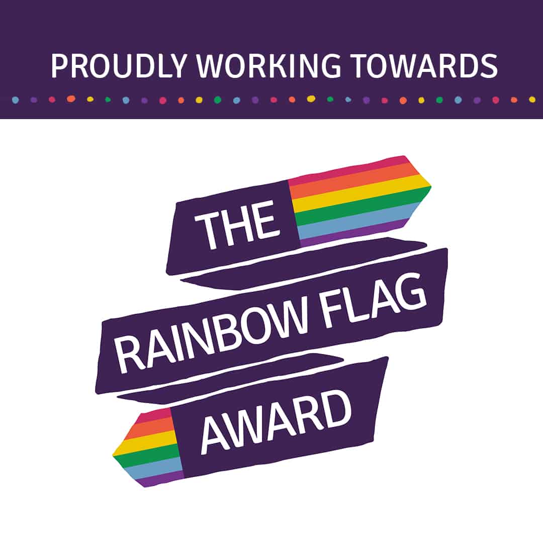An official badge that reads 'Proudly working towards the rainbow flag award', given to Laurus Ryecroft.