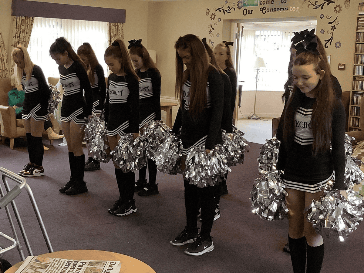 Students from Laurus Ryecroft lined up at the start of their cheerleading routine at Hurst Hall Care Home.